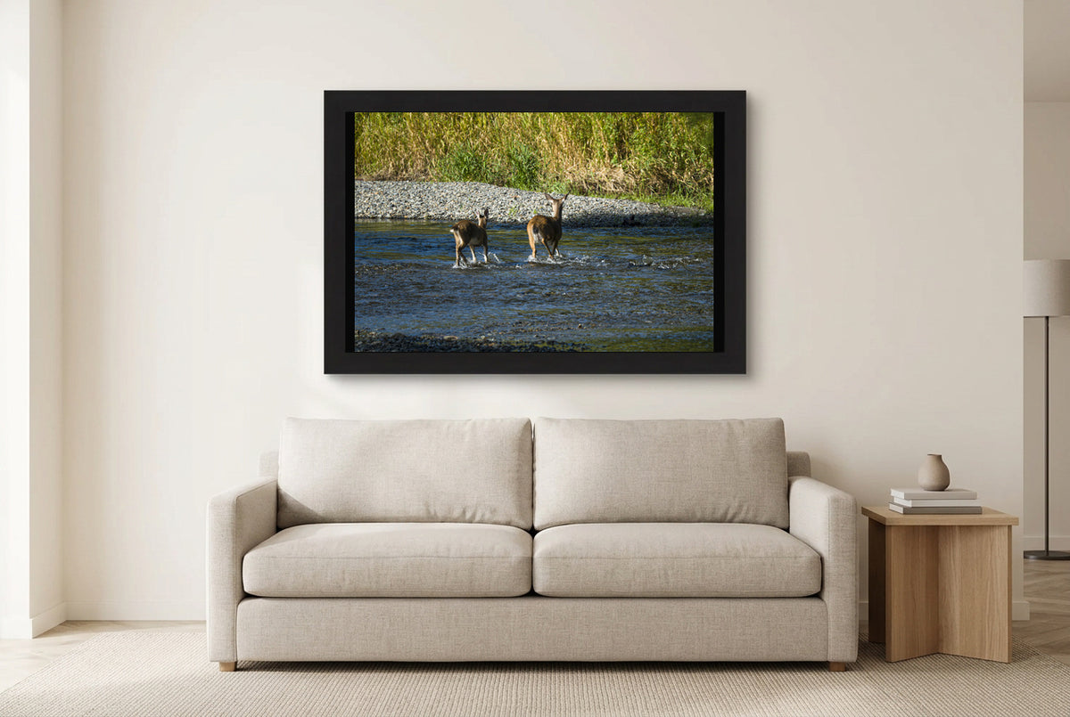 Illustrative room preview of Crossing Together in a black frame above a light sofa. Artwork scale is approximate.