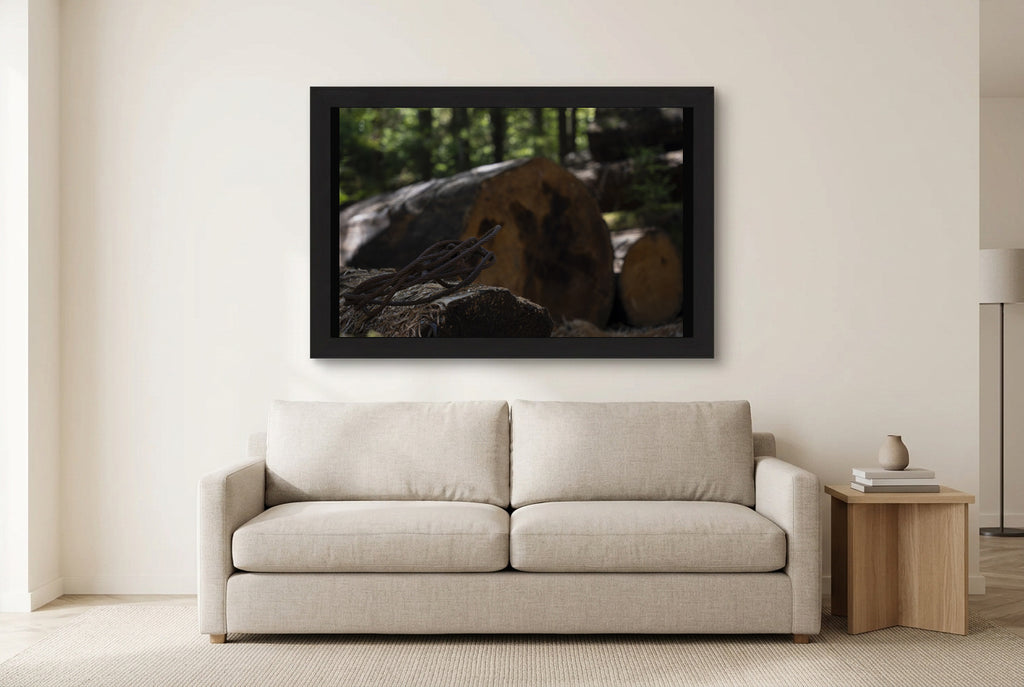 Illustrative room preview of Remnants of the Timberline in a black frame above a light sofa. Artwork scale is approximate.