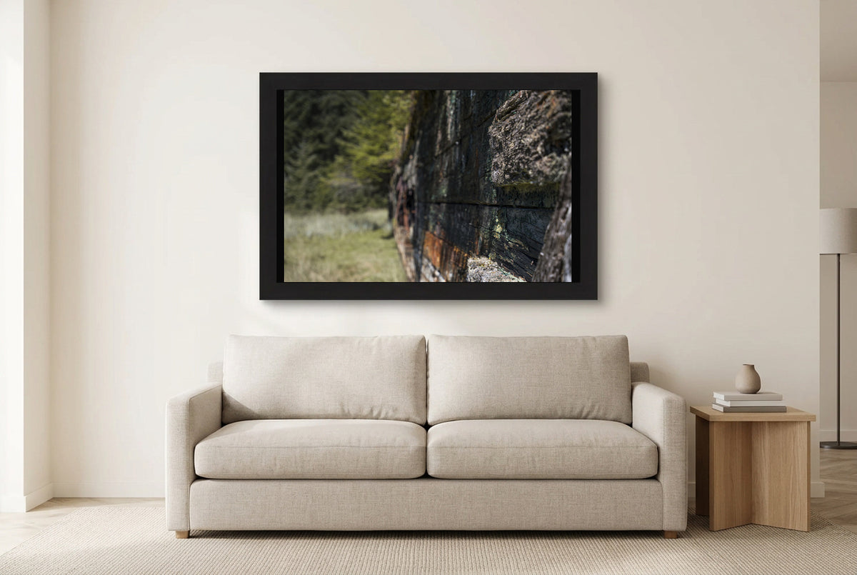 Illustrative room preview of Weathered by Time in a black frame above a light sofa. Artwork scale is approximate.