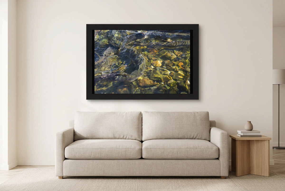 Illustrative room preview of Riverlight in a black frame above a light sofa. Artwork scale is approximate.