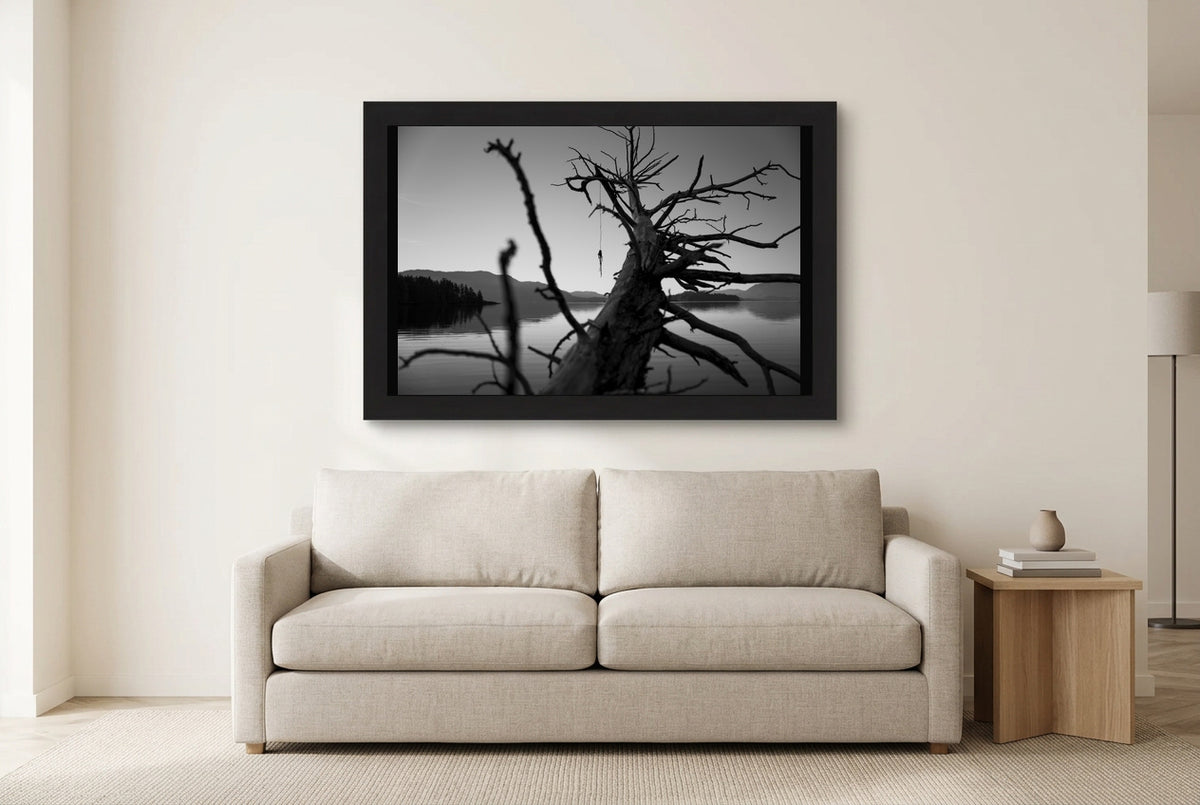 Illustrative room preview of The Fallen Sentinel in a black frame above a light sofa. Artwork scale is approximate.
