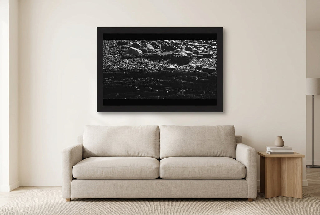 Illustrative room preview of Layers of the Shore in a black frame above a light sofa. Artwork scale is approximate.
