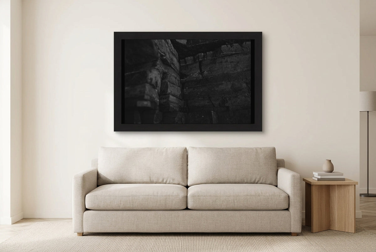 Illustrative room preview of Within the Stone in a black frame above a light sofa. Artwork scale is approximate.