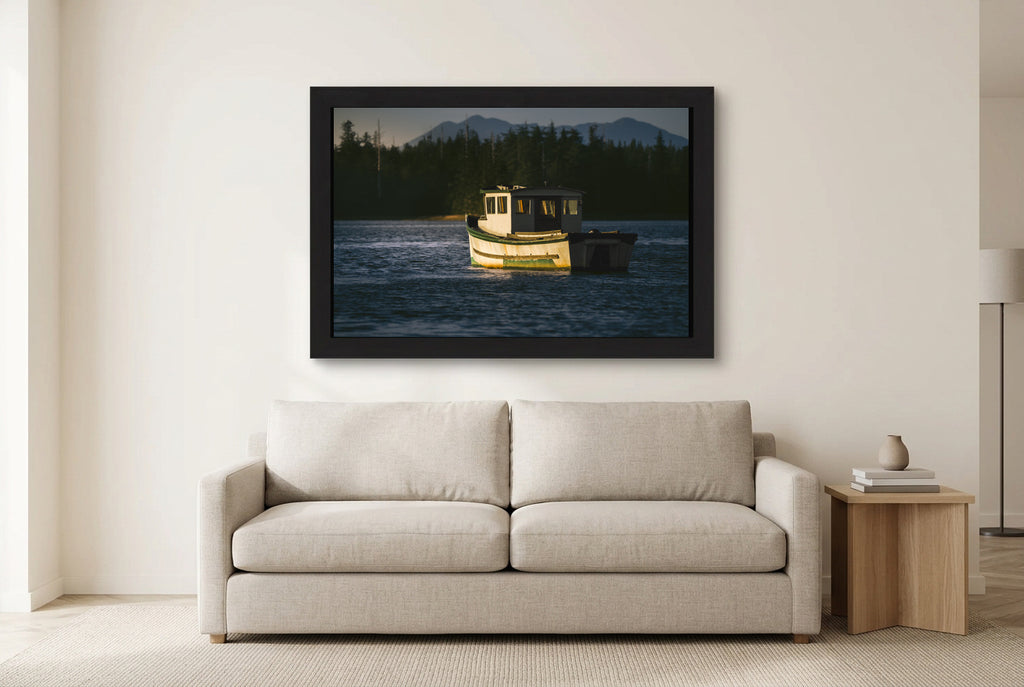 Illustrative room preview of The Quiet Anchorage in a black frame above a light sofa. Artwork scale is approximate.