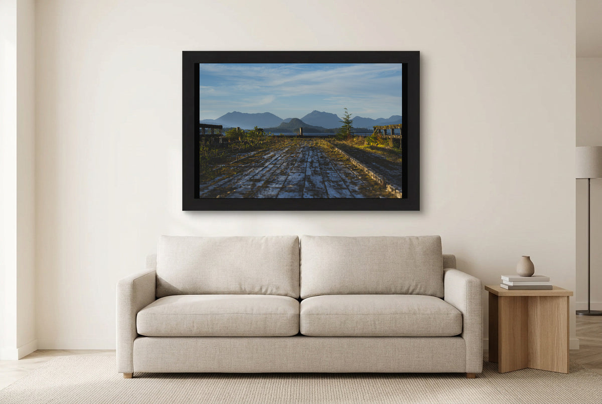 Illustrative room preview of A Place Reclaimed in a black frame above a light sofa. Artwork scale is approximate.