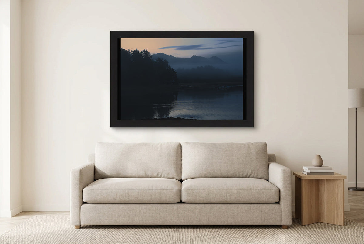 Illustrative room preview of Stillness in Color in a black frame above a light sofa. Artwork scale is approximate.