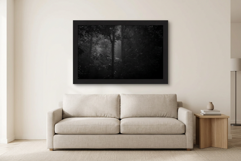 Illustrative room mockup of Morning Mist in a black frame above a light sofa. Artwork scale is approximate.
